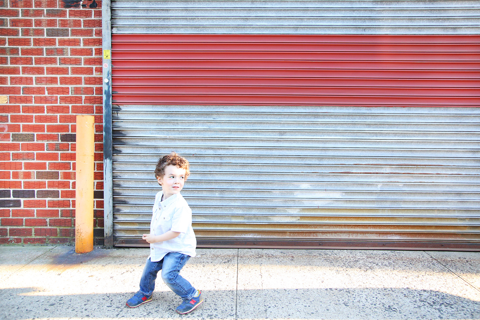 boy running on sidewalk
